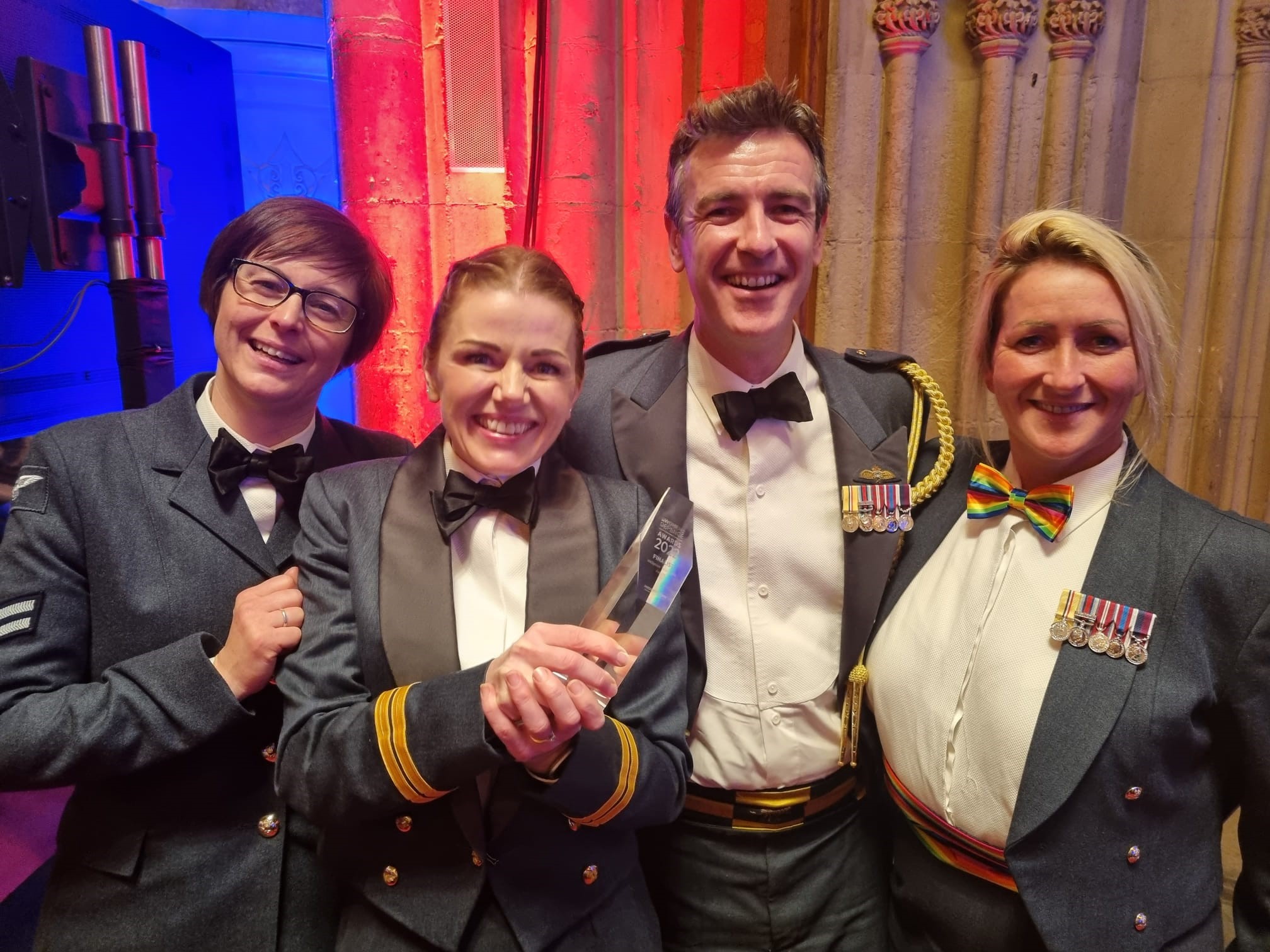 Image shows personnel holding award.